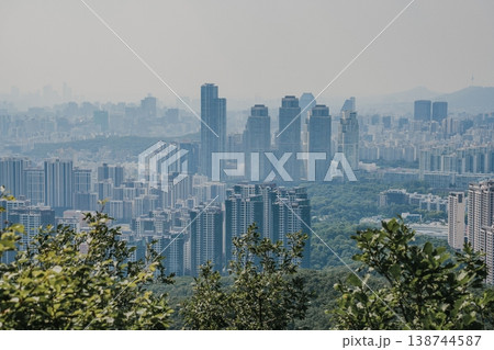 Panoramic view of Seoul city skyline with high-rise buildings and mountains from Daemosan mountain peak. Panoramic view of Seoul city skyline with high-rise buildings and mountains from Daemosan mountain peak. 138744587