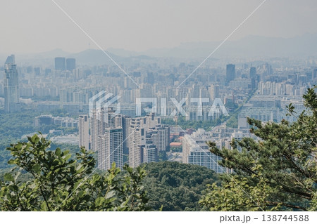 Panoramic view of Seoul city skyline with high-rise buildings and mountains from Daemosan mountain peak. Panoramic view of Seoul city skyline with high-rise buildings and mountains from Daemosan mountain peak. 138744588