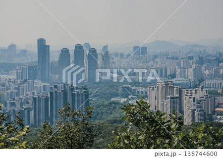 Panoramic view of Seoul city skyline with high-rise buildings and mountains from Daemosan mountain peak. Panoramic view of Seoul city skyline with high-rise buildings and mountains from Daemosan mountain peak. 138744600