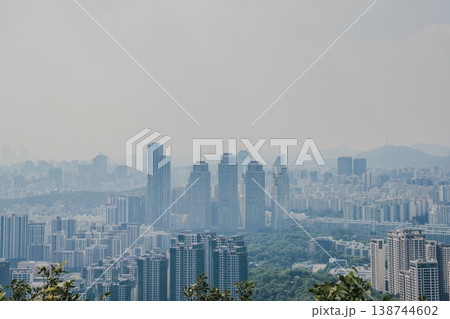 Panoramic view of Seoul city skyline with high-rise buildings and mountains from Daemosan mountain peak. Panoramic view of Seoul city skyline with high-rise buildings and mountains from Daemosan mountain peak. 138744602