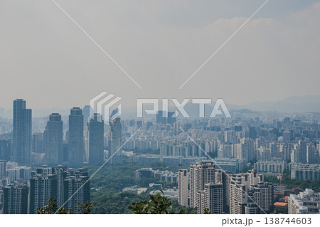 Panoramic view of Seoul city skyline with high-rise buildings and mountains from Daemosan mountain peak. Panoramic view of Seoul city skyline with high-rise buildings and mountains from Daemosan mountain peak. 138744603