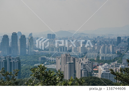 Panoramic view of Seoul city skyline with high-rise buildings and mountains from Daemosan mountain peak. Panoramic view of Seoul city skyline with high-rise buildings and mountains from Daemosan mountain peak. 138744606