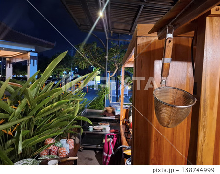 Peaceful night atmosphere at a street food stall, a documentary scene with a noodle strainer Peaceful night atmosphere at a street food stall, a documentary scene with a noodle strainer 138744999