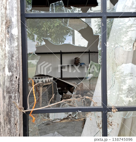 Gritty Cinematic scene of damaged building with broken glass and debris 138745096
