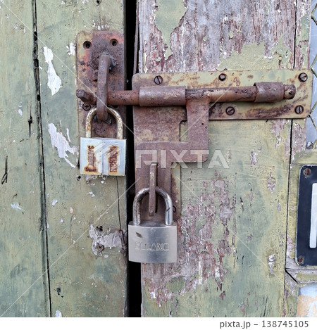 Vintage Rustic Door with Old Locks and Peeling Green Paint Vintage Rustic Door with Old Locks and Peeling Green Paint 138745105