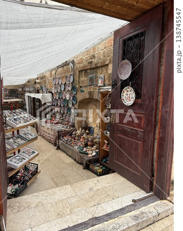 Street market stall displaying various traditional handicrafts and pottery in outdoor setting Street market stall displaying various traditional handicrafts and pottery in outdoor setting 138745547