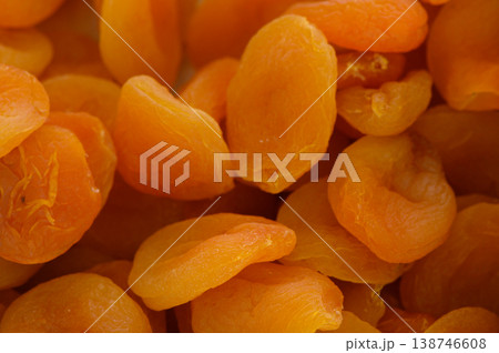 Sweet and tangy dried apricots piled high in a vibrant display at a bustling market in summer Sweet and tangy dried apricots piled high in a vibrant display at a bustling market in summer 138746608