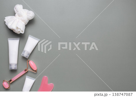 Skincare beauty tools and cosmetic tubes with facial roller, gua sha and cleansing cloth on neutral background Skincare beauty tools and cosmetic tubes with facial roller, gua sha and cleansing cloth on neutral background 138747087