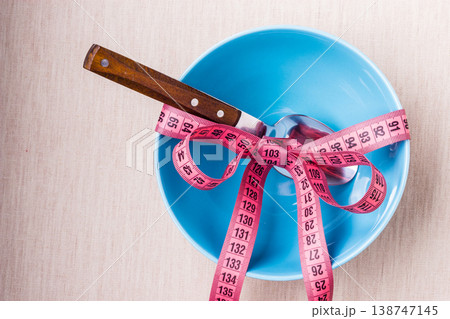 Measuring tape around empty bowl on table Measuring tape around empty bowl on table 138747145