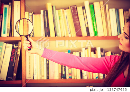 Hipster girl holding magnifying glass Hipster girl holding magnifying glass 138747436