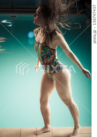 Woman in swimsuit stand at edge swimming pool. 138747437