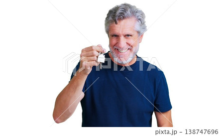 Smiling man holding house keys celebrating homeownership on transparent background 138747696