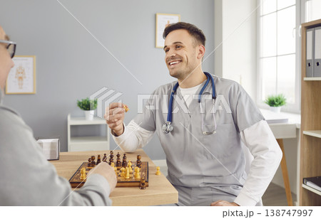 Nurse man playing chess game with a senior person in clinic or in retirement home. 138747997