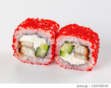 Close-up of two Japanese sushi rolls with eel, cream cheese, and red tobiko roe on a white background. Close-up of two Japanese sushi rolls with eel, cream cheese, and red tobiko roe on a white background. 138748336