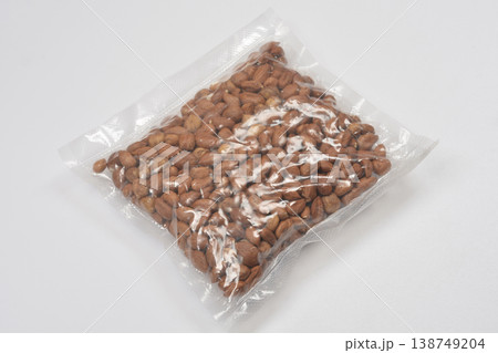 Vacuum packed hazelnuts on white background Vacuum packed hazelnuts on white background 138749204