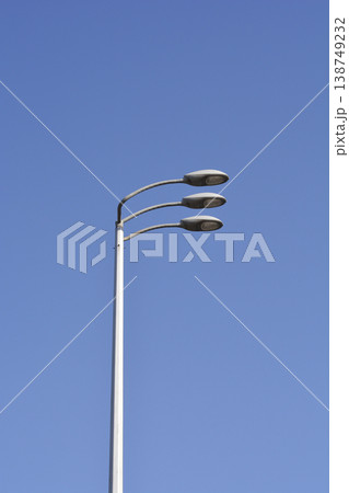 Modern Triple Street Lamp Against Blue Sky Modern Triple Street Lamp Against Blue Sky 138749232