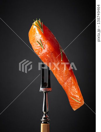 Smocked salmon fillet on a black background. Smocked salmon fillet on a black background. 138749464