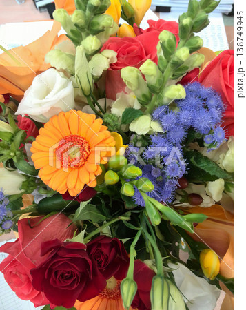 Beautiful mixed flower arrangement featuring gerbera daisies, roses, and statice 138749945