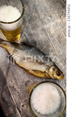 Fishing scene with fish on wood, beer glasses nearby Fishing scene with fish on wood, beer glasses nearby 138749952