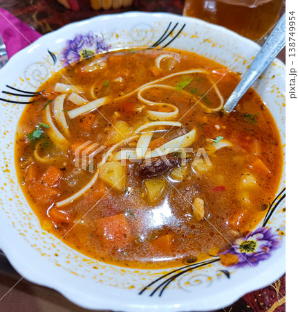 Hearty homemade beef noodle soup with carrots and potatoes, top view. Hearty homemade beef noodle soup with carrots and potatoes, top view. 138749954