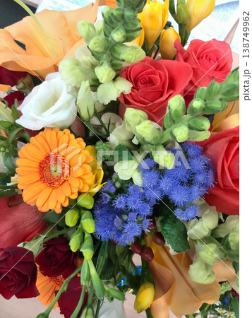 Beautiful mixed flower arrangement featuring gerbera daisies, roses, and statice Beautiful mixed flower arrangement featuring gerbera daisies, roses, and statice 138749962