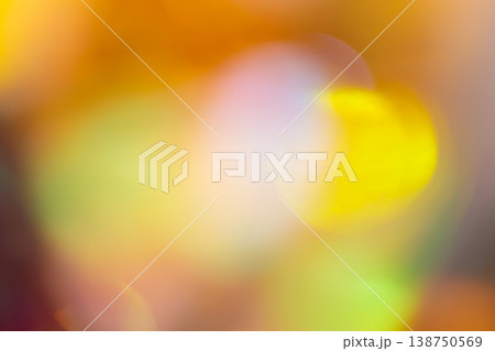 Warm yellow and orange abstract bokeh background with glowing light circles on blurred backdrop 138750569