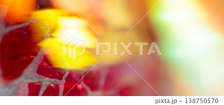 Red translucent crystal pieces and yellow flower bokeh on warm abstract background 138750570