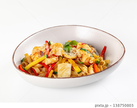 Stir-fried rice noodles with shrimp, squid, and mixed vegetables in a ceramic bowl isolated on white. Stir-fried rice noodles with shrimp, squid, and mixed vegetables in a ceramic bowl isolated on white. 138750803