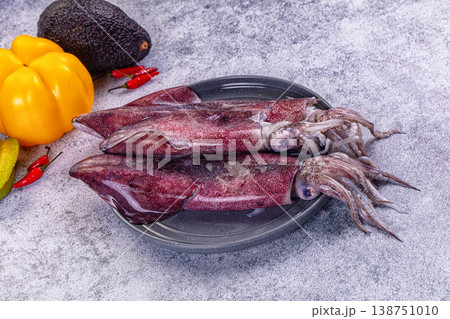 Fresh raw squid on a plate with exotic vegetables for cooking Fresh raw squid on a plate with exotic vegetables for cooking 138751010