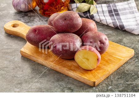 Raw red organic potato over board 138751104
