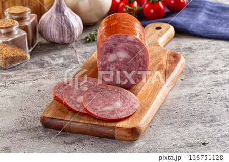 Ham sausage with slice over board Ham sausage with slice over board 138751128