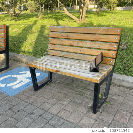 tablet on the left on the bench. place for disabled person tablet on the left on the bench. place for disabled person 138751542