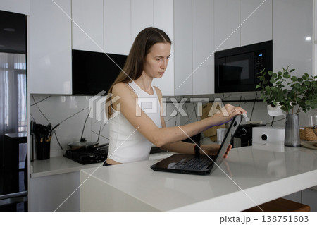 Young woman cleaning her laptop at home Young woman cleaning her laptop at home 138751603