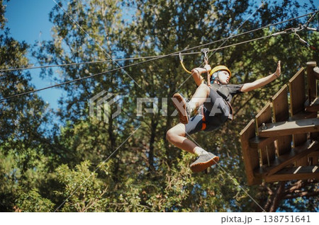 Teen Enjoying Zipline Adventure in Forest Park 138751641