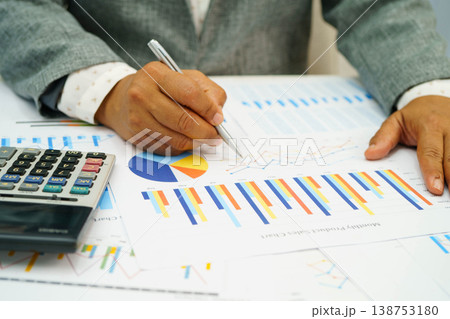 Asian business woman working with financial graph. Asian business woman working with financial graph. 138753180