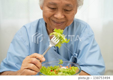 Asian elderly woman patient holding healthy food for patient in hospital, nutrition and vitamin. Asian elderly woman patient holding healthy food for patient in hospital, nutrition and vitamin. 138753494