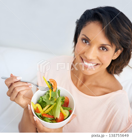 Lunch, salad and portrait of happy woman eating for nutrition, health and wellness in diet. Healthy food, fruit and vegetables in bowl for meal on sofa in home living room with happiness and a smile Lunch, salad and portrait of happy woman eating for nutrition, health and wellness in diet. Healthy food, fruit and vegetables in bowl for meal on sofa in home living room with happiness and a smile 138755649