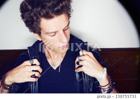 Man with confidence, punk fashion and rock attitude in leather jacket with spotlight. Cool rockstar style, modern grunge and thinking, handsome male model with designer clothes, jewellery and culture Man with confidence, punk fashion and rock attitude in leather jacket with spotlight. Cool rockstar style, modern grunge and thinking, handsome male model with designer clothes, jewellery and culture 138755731