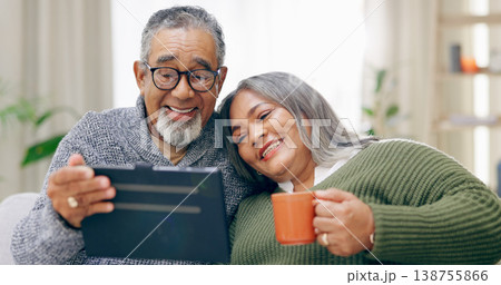 Tablet, home and senior couple with retirement, relax and coffee with happiness, social media and cheerful. Apartment, elderly woman and old man with tech, tea and relationship with marriage or app 138755866
