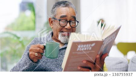 Elderly man, book and coffee on sofa with smile, reading or relax in retirement in home living room. Senior african person, literature and happy with tea for knowledge, thinking and drink on couch Elderly man, book and coffee on sofa with smile, reading or relax in retirement in home living room. Senior african person, literature and happy with tea for knowledge, thinking and drink on couch 138755937