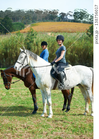 Women friends, horse riding and smile in portrait with helmet, ranger team or equestrian exercise. Girl outdoor together, jockey or happy on adventure, training or learning for contest in countryside 138756017