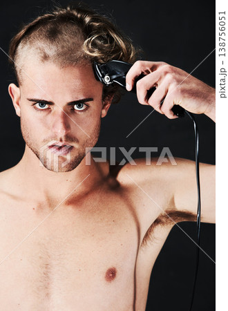 Portrait, body and serious man shaving hair or head in studio isolated on a black background. Face, haircut machine and naked person at hairdresser salon with trimmer for wellness, care and hairstyle 138756051
