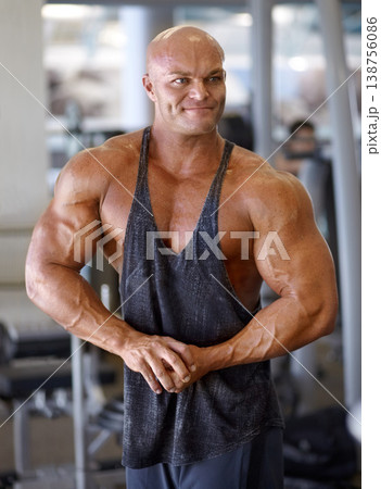 Body builder, flex and man in a gym with power, weightlifting and strength at a sport club. Muscle, strain and strong male athlete with training for bodybuilder fitness and wellness for workout 138756086