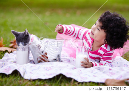 Milk, picnic and a girl in the park with her kitten together for love, care or bonding during summer. Smile, cat or kids playing and a cute young child in the garden having fun with her pet animal Milk, picnic and a girl in the park with her kitten together for love, care or bonding during summer. Smile, cat or kids playing and a cute young child in the garden having fun with her pet animal 138756147