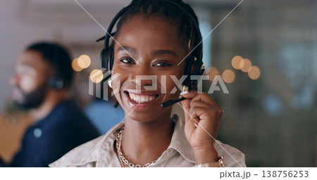 Portrait, happy and black woman at call center on headphones for crm support on bokeh at night. Face, sales agent smile and telemarketing consultant, customer service professional or worker in office Portrait, happy and black woman at call center on headphones for crm support on bokeh at night. Face, sales agent smile and telemarketing consultant, customer service professional or worker in office 138756253