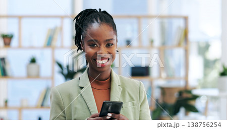 Happy black woman, portrait and phone for business, social media or networking at office. African female person or employee smile with mobile smartphone for online chatting, texting or communication 138756254