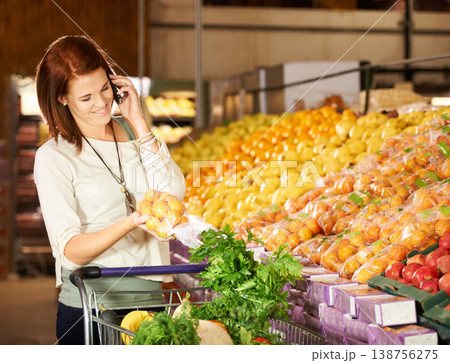 Woman, talking and smartphone with vegetable shopping for healthy food, supermarket and communication. Happy, person and call on cellphone at grocery retail, fruit and wellness store for nutrition 138756275