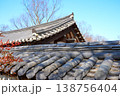 Layered Traditional Korean Hanok Tiled Roofs with Pine Trees under Blue Sky 138756404