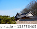 Layered Traditional Korean Hanok Tiled Roofs with Pine Trees under Blue Sky 138756405