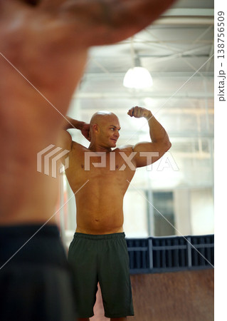 Strong man, arm flexing and mirror at gym with fitness, workout and exercise of bodybuilder with reflection. Muscle, male person and athlete with training, wellness and body builder at a health club Strong man, arm flexing and mirror at gym with fitness, workout and exercise of bodybuilder with reflection. Muscle, male person and athlete with training, wellness and body builder at a health club 138756509